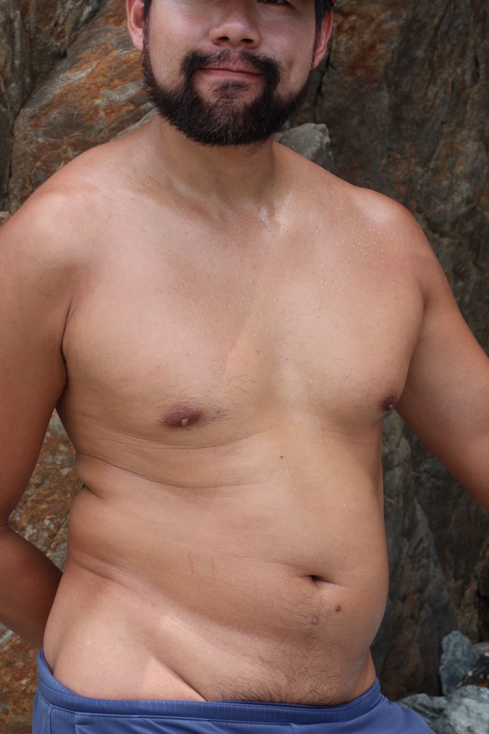 High tie with the wave sounds. Rocks and mountains behind me. I am naked like a part of nature.